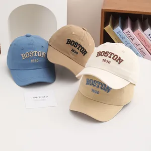 Detailed close-up of Boston 1630 embroidery on cotton twill baseball caps for kids