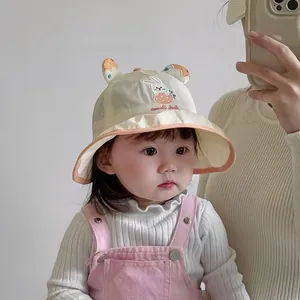 Close-up of baby sun hat featuring strawberry rabbit embroidery and breathable mesh lining
