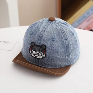 Close-up of the cartoon embroidery and high-quality denim fabric on child's baseball cap
