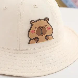 Detailed close-up of beige capybara bucket hat for kids with 3D cartoon patch and vents