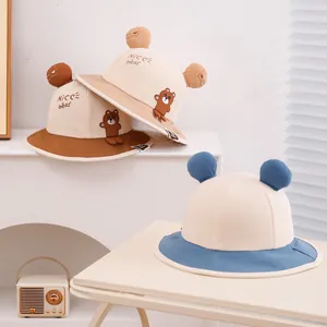 Three children's sun hats with bear ears and cartoon embroidery in assorted colors