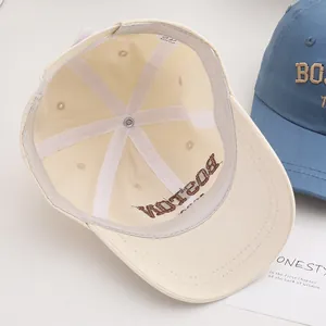 Detail of BOSTON letter towel embroidery and interior stitching on a kids baseball cap