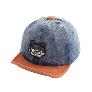 Kids denim baseball cap with brown brim and cute cartoon embroidery on blue wash fabric