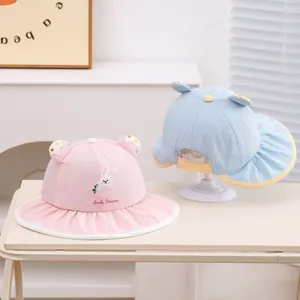 Detail of pink and blue kids sun hats with breathable mesh and cute rabbit embroidery