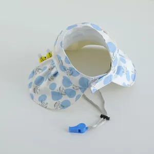 Detail of children's sun visor with adjustable wind rope and blue survival whistle