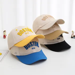 Detailed close-up of kids mesh baseball caps with 3D BOSTON embroidery in four colors