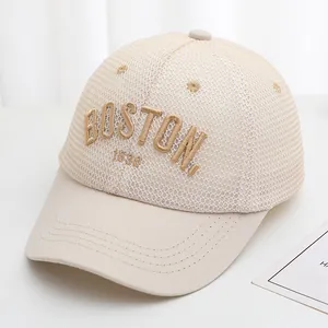 Close-up of BOSTON 1630 embroidery on breathable beige mesh baseball cap for kids