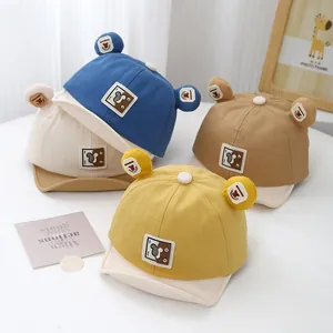 Detail of baby soft baseball caps in four colors featuring cute cartoon bear ears