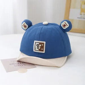 Detail of the blue and beige baby baseball cap featuring cute 3D bear ears and embroidery