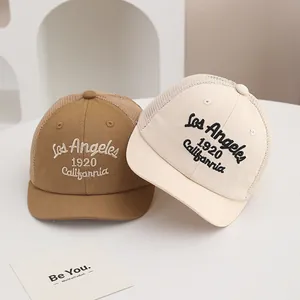 Detail of embroidered Los Angeles logo and breathable mesh on children's baseball caps