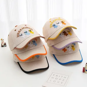 Detail of six colorful toddler mesh baseball caps with bear embroidery and curved brims