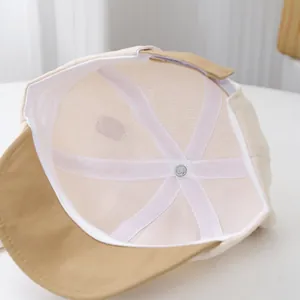 Internal view of a soft cotton baby baseball cap with reinforced stitching and logo tag