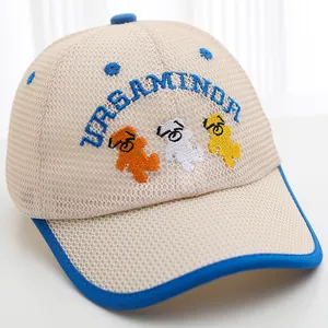 Detail of breathable beige mesh fabric and cute bear embroidery on toddler baseball cap