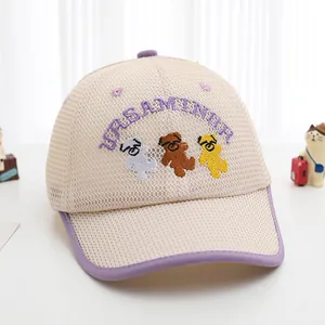Close-up of breathable mesh fabric and cartoon bear embroidery on kids baseball cap