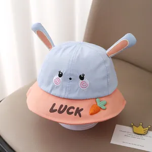 Detail of baby sun hat featuring 3D rabbit ears, lucky text and carrot decoration