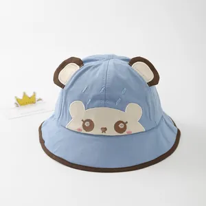 Close-up of light blue baby bucket hat featuring 3D ears and cute bear embroidery
