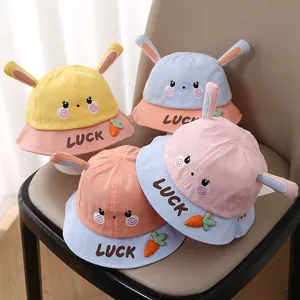 Detail of four baby sun hats with bunny ears and carrot patches in pastel colors