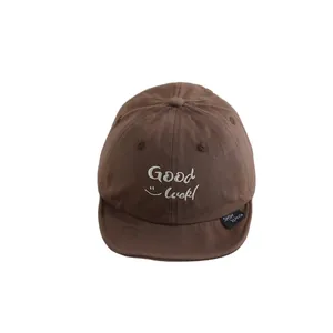 Brown canvas baby baseball cap with Good Luck embroidery and soft brim for infants