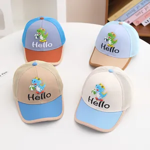 Detail of four colorful kids mesh baseball caps with cute dinosaur patches and Hello embroidery
