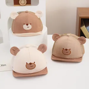 Detailed view of baby mesh caps with embroidered bear face and soft brim in three colors