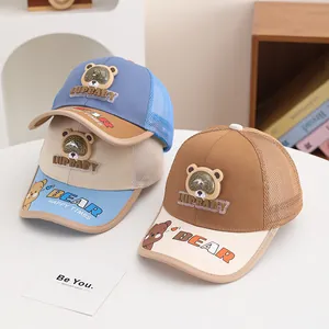 Detail of breathable mesh panels and cute bear patches on colorful summer kids' baseball caps