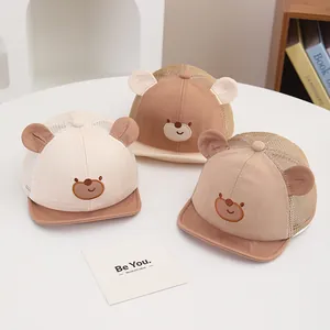 Detailed view of baby mesh baseball caps with bear ears and embroidery in neutral tones