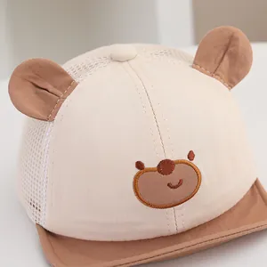 Detailed close-up of cute bear embroidery and breathable mesh on baby baseball sun hat