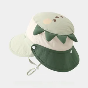 Detail of baby sun hat showing dinosaur spikes and adjustable side snap buttons