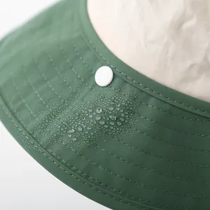 Close-up of quick-dry fabric texture with water droplets on wide brim sun hat