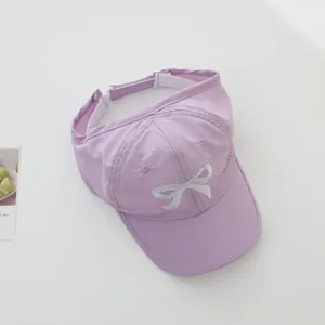Detail of lavender sun visor hat with silver bow embroidery and adjustable back strap