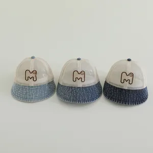 Mesh baby sun hat with denim brim and smiley M embroidery in three denim shades