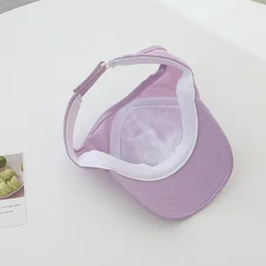 Detail of adjustable velcro closure and breathable mesh lining on lavender sun visor