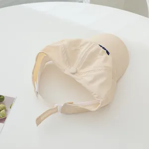 Classic beige cotton baseball cap with blue embroidery on white background