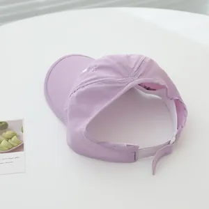 Detail of light purple sun visor with white heart embroidery and Velcro strap