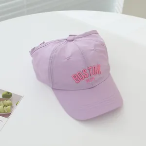 Detailed close-up of pink BOSTON 1630 embroidery on a light purple quick-dry cap