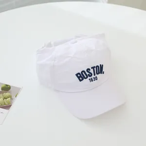 Close-up of Boston 1630 navy embroidery on a white quick-dry cotton baseball cap