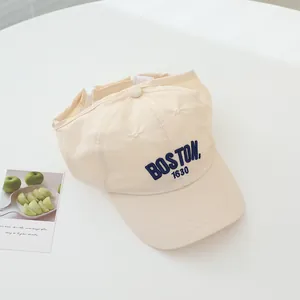 Detailed close-up of BOSTON 1630 embroidery on beige quick-dry visor cap for kids