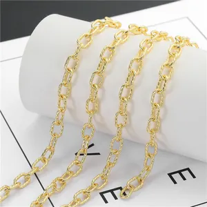 Macro shot of gold oval-link chain with textured twist finish for DIY jewelry crafting