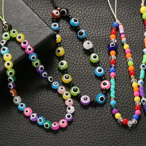 Colorful Evil Eye phone charm strap with rainbow polymer clay beads and gold spacers