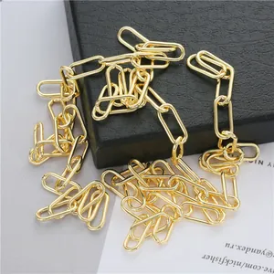 Detailed view of polished light gold paperclip chain link segments for DIY jewelry