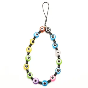 Detailed view of handmade colorful evil eye beads and black spacer beads on phone strap