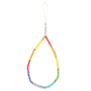 Detailed view of rainbow crystal beads phone strap with LOVE letter charms and gold spacers