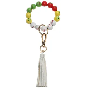 Detail of Christmas beaded keychain with colorful wooden beads and white leather tassel