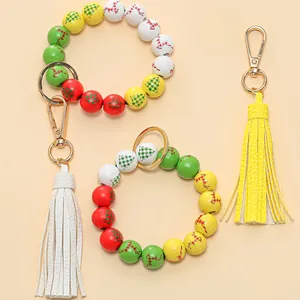 Detail of Christmas wooden bead bracelet featuring reindeer prints and leather tassels