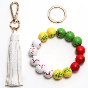 Detailed view of Christmas wooden bead wristlet with PU leather tassel and golden clasp