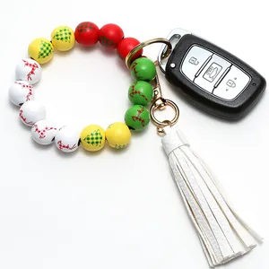 Close-up of Christmas wooden beads bracelet keychain with white leather tassel and elk patterns