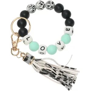 Detail of leopard print beads and LOVE letter square beads with leather tassel keychain