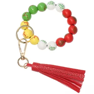 Detail of Christmas reindeer wooden bead keychain with red PU leather tassel and gold ring