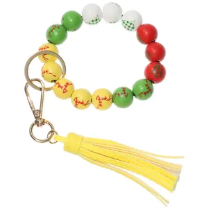 Close-up of Christmas wooden beads with elk tree prints and yellow leather tassel
