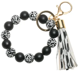 Detailed macro view of leopard print beads and matching tassel on a silicone keychain ring